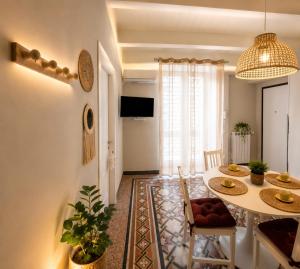 a living room with a table and a dining room at Maison La Reggia in Caserta