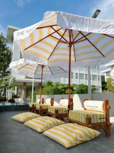 a row of chairs under umbrellas on a patio at THE NAVY HOUSE HOTEL in Sattahip