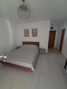 a bedroom with a bed in a white room at Apartment Sommer-Tango in Byala +1 photo