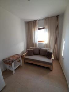 a living room with a couch and a window at Apartment Sommer-Tango in Byala