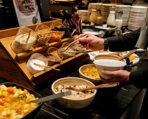 a group of people preparing food at a buffet at Radisson Blu Elizabete Hotel, Riga in Riga