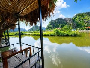 a view of a river from a hut at Trang An River Sunshine in Ninh Binh