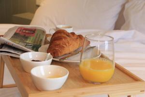 a tray with a plate of food and a glass of orange juice at Sundaywell Cottage in Killyleagh +13 photos