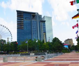 a tall building with a ferris wheel in front of it at Atlanta Resort 1BR Apartment in Atlanta