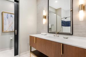 a bathroom with a sink and a mirror at Atlanta Resort 1BR Apartment in Atlanta +15 photos