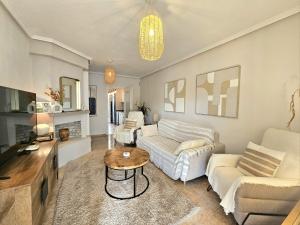 a living room with two couches and a table at Chalet con Piscina Privada, Aguas Nuevas, Torrevieja in Torrevieja