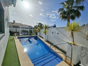 a swimming pool on the side of a house at Chalet con Piscina Privada, Aguas Nuevas, Torrevieja in Torrevieja