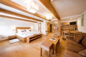 a large room with a bed and a living room at U Černého medvěda in Jablonné nad Orlicí