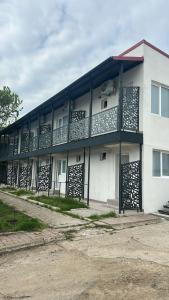 a white building with a lot of balconies on it at Vila DVG Tineret in Schitul