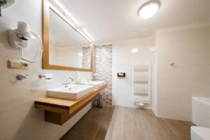 a white bathroom with a sink and a mirror at U Černého medvěda in Jablonné nad Orlicí +58 photos