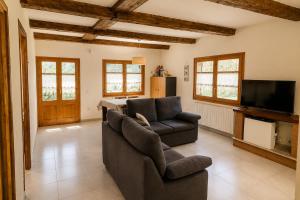 a living room with two chairs and a television at Winahost Espunyola Berga in L'Espunyola