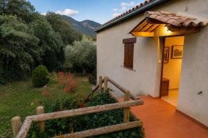 a house with a wooden fence next to a garden at Winahost Espunyola Berga in L'Espunyola +7 photos