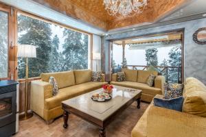 a living room with couches and a table at Hotel Royal Castle in Gulmarg