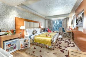 a hotel room with a bed and a desk at Hotel Royal Castle in Gulmarg