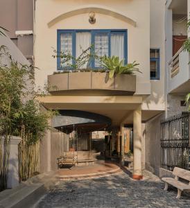 a building with a window with plants on it at TONG Boutique Hotel in Phan Thiet