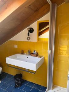 a bathroom with a sink and a yellow wall at fairytale home - panorama in Agropoli +27 photos