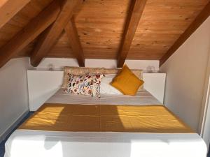 a bed in the attic of a room with wooden ceilings at fairytale home - panorama in Agropoli