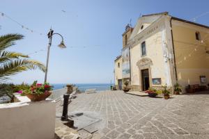 a building on a street with the ocean in the background at fairytale home - panorama in Agropoli