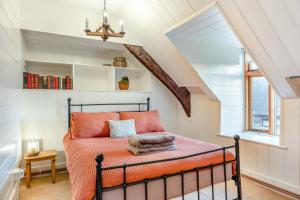 a bedroom with an orange bed in a attic at Y Cwtch - Panoramic mountain views within Snowdonia's National Park - 4x4 only in Dolgellau