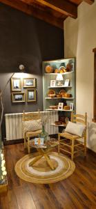 a living room with a table and a couch and chairs at Cal Riol in Talarn