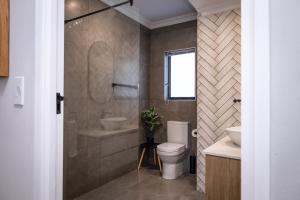 a bathroom with a toilet and a sink at Taluga Beach Villa in St. Helena Bay +38 photos