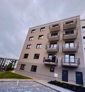 a tall building with balconies on the side of it at Serenity Apartment in Mariánské Lázně