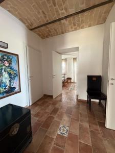 a living room with a tile floor and a painting on the wall at Glamping Uma Casanatura in Cellino Attanasio
