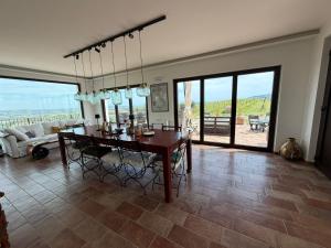a living room with a dining room table with a view at Glamping Uma Casanatura in Cellino Attanasio