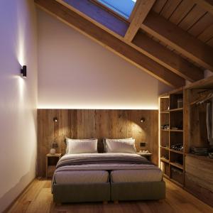 a bedroom with a large bed and wooden walls at Ma Chérie in Livigno
