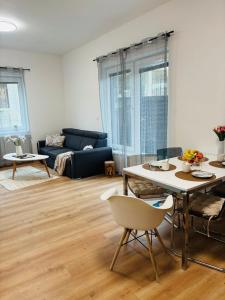 a living room with a table and a couch at Serenity Apartment in Mariánské Lázně