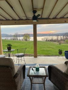 a screened in porch with a view of the water at Beacon Hudson Hideaway in Beacon