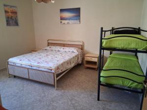 a bedroom with two bunk beds in a room at Casa vacanze ESTER in San Foca