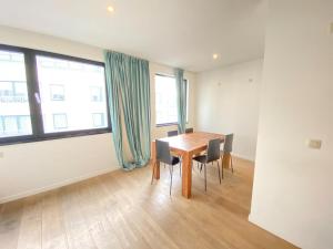 a dining room with a wooden table and chairs at 12-Guest Apartment on the Main Square in Antwerp