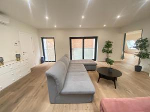 a living room with a couch and a table at 12-Guest Apartment on the Main Square in Antwerp