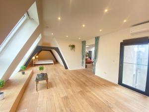a large living room with a staircase in a house at 12-Guest Apartment on the Main Square in Antwerp