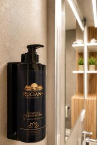 a bottle of soap sitting on a bathroom sink at Ruciane Residence in Ruciane-Nida +90 photos