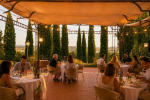 a group of people sitting at tables in a restaurant at Terracqua Retreat I Essence of Tuscany in Chiusi
