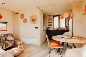 a living room with a table and a couch at Tiny Cabana in Scharendijke