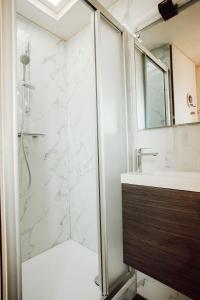 a bathroom with a shower and a sink at Tiny Cabana in Scharendijke +44 photos