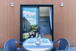 a blue table with plates on it on a patio at Le Cocon de Brocéliande - Studio cosy et indépendant in Saint-Thurial