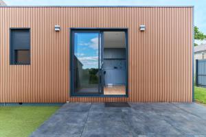 a building with a large glass door on it at Le Cocon de Brocéliande - Studio cosy et indépendant in Saint-Thurial