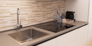 a kitchen counter with a sink and a water bottle at Gomes Comfort House 2 in Valeggio sul Mincio +71 photos
