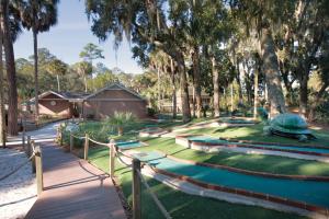 a resort yard with a pool and trees at Ocean Ridge Resort 2BR Apartment in Edisto Island