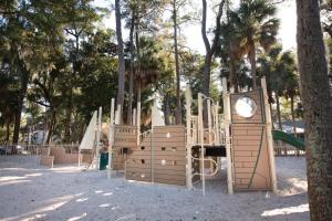 a playground in a park with trees and a clock at Ocean Ridge Resort 4BR Apartment in Edisto Island