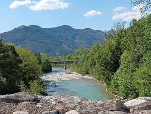 a river with a bridge in the background with trees at Charme - Centre historique de Die in Die