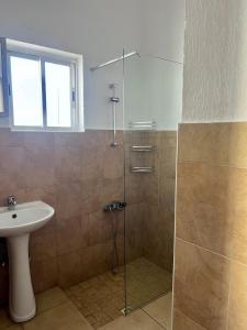 a bathroom with a shower and a sink at Central Stone Living in Peyia