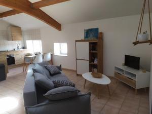 a living room with a couch and a table at Charme - Centre historique de Die in Die