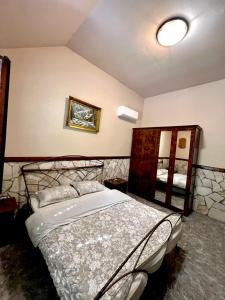 a bedroom with a bed and a mirror at Forest Home in Golubovci +29 photos