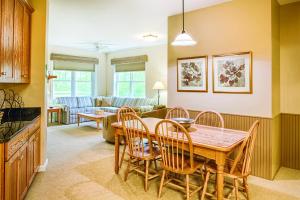 a dining room and living room with a table and chairs at Smugglers' Notch Resort 2BR Apartment in Cambridge