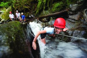 a girl in a red helmet on a waterfall at Smugglers' Notch Resort 2BR Apartment in Cambridge